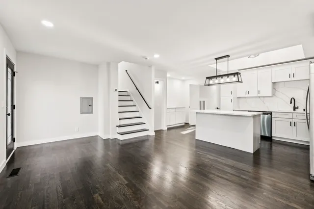a view of kitchen with wooden floor and electronic appliances
