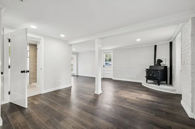 a view of a livingroom with wooden floor and furniture