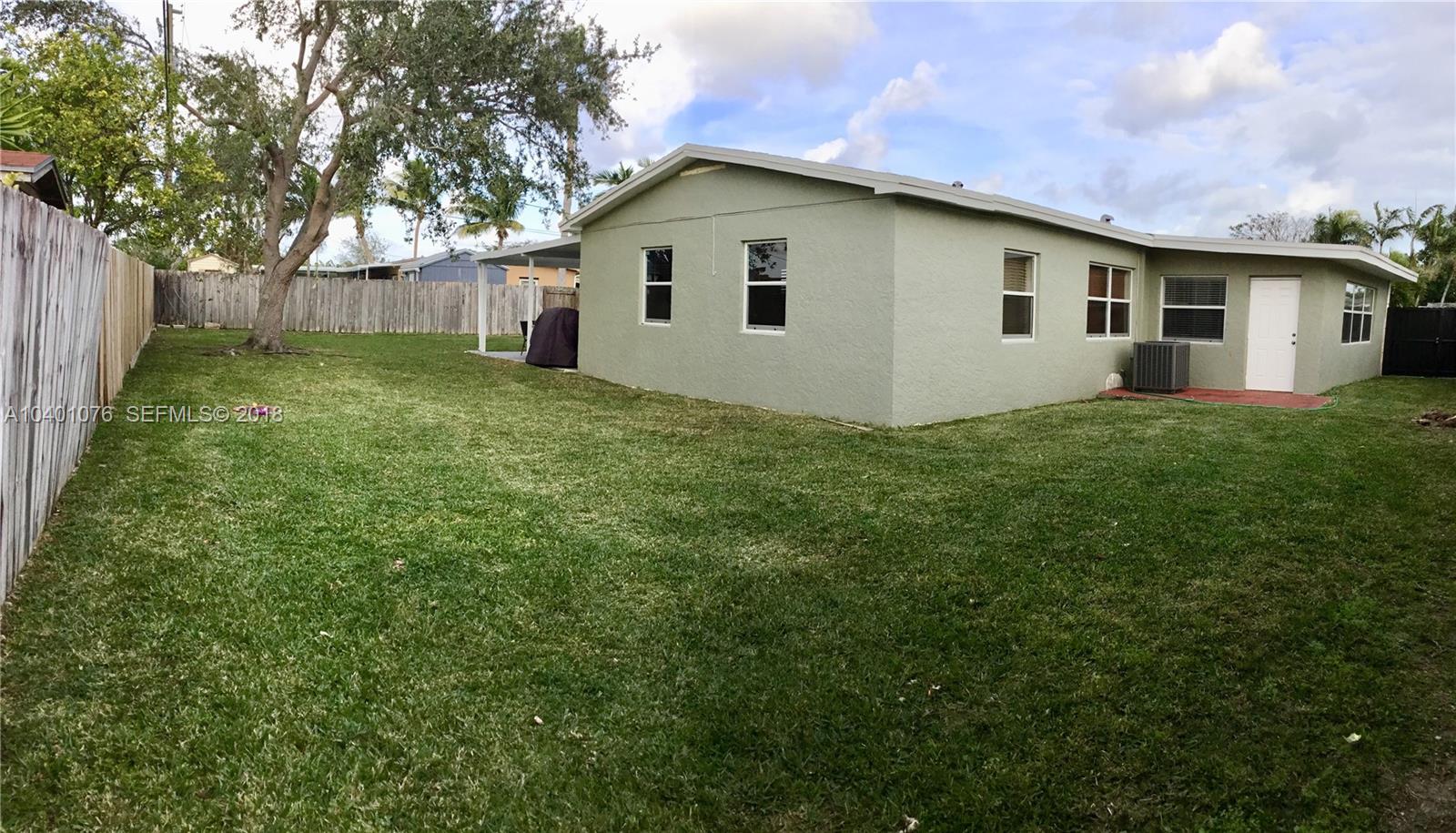 20010 Island Road Cutler Bay, FL 33189 - Photo 20 of 24 a front view of a house with a garden