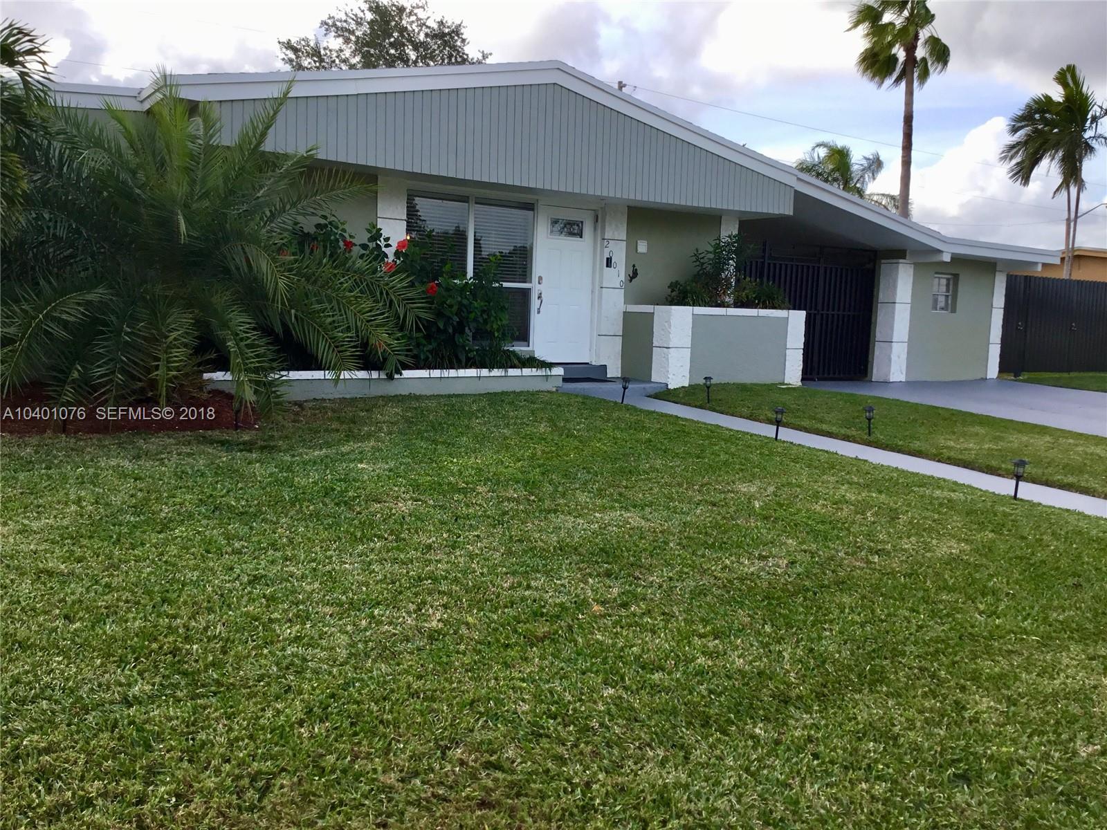 20010 Island Road Cutler Bay, FL 33189 - Photo 2 of 24 a front view of a house with a garden