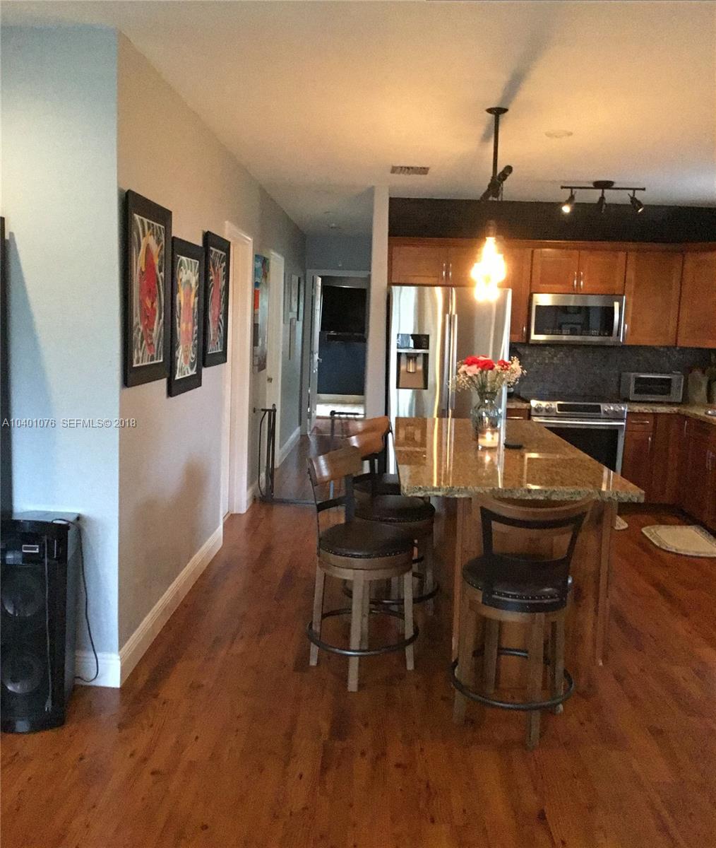 20010 Island Road Cutler Bay, FL 33189 - Photo 7 of 24 a kitchen with a table and chairs