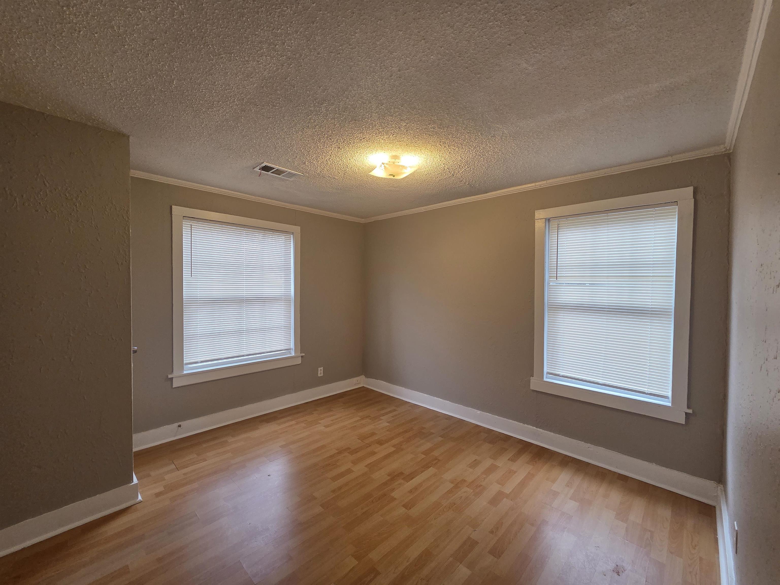 3458 Radford Road Memphis, TN 38111 - Photo 12 of 18 an empty room with wooden floor and windows