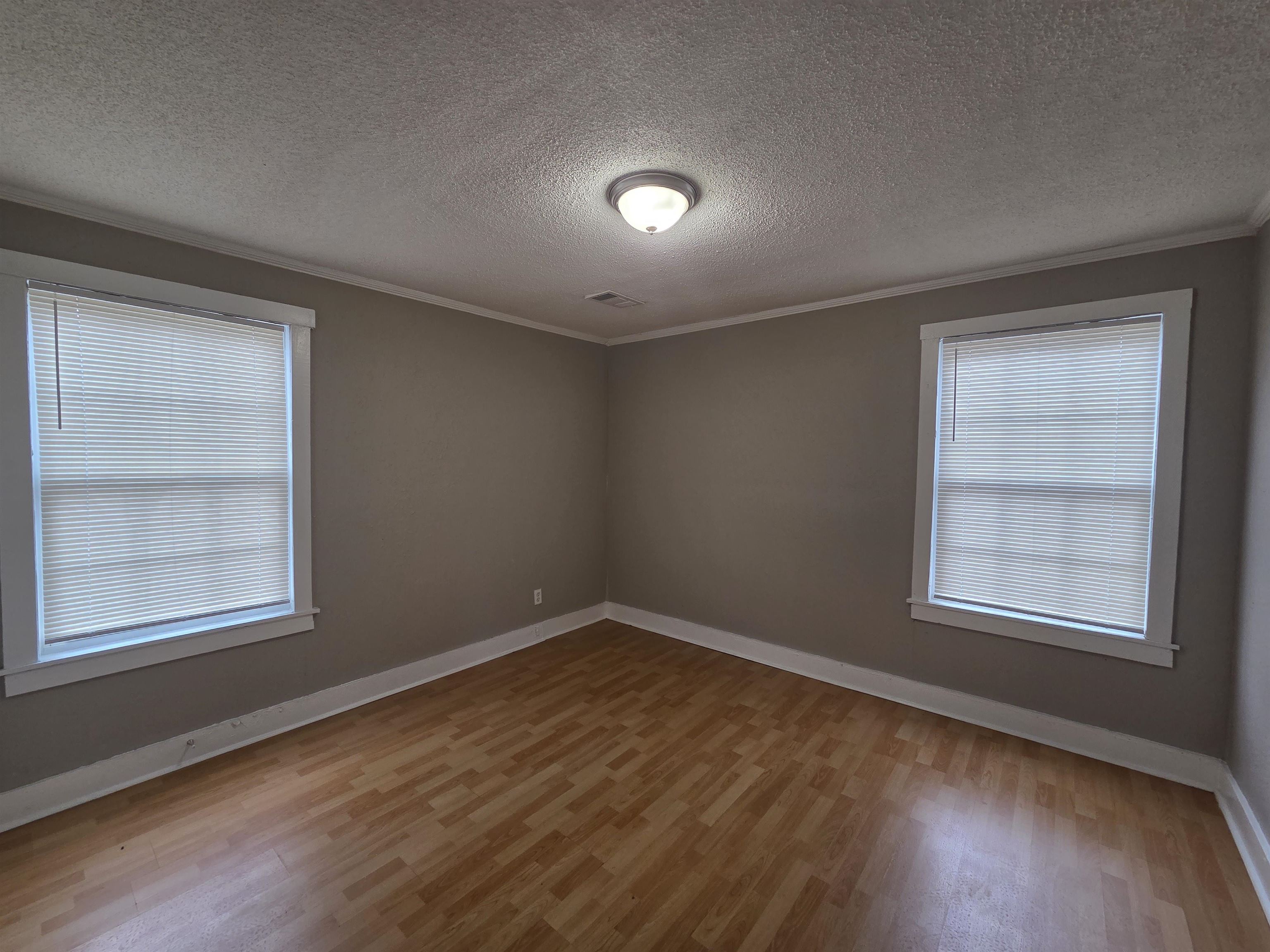3458 Radford Road Memphis, TN 38111 - Photo 15 of 18 an empty room with wooden floor and windows