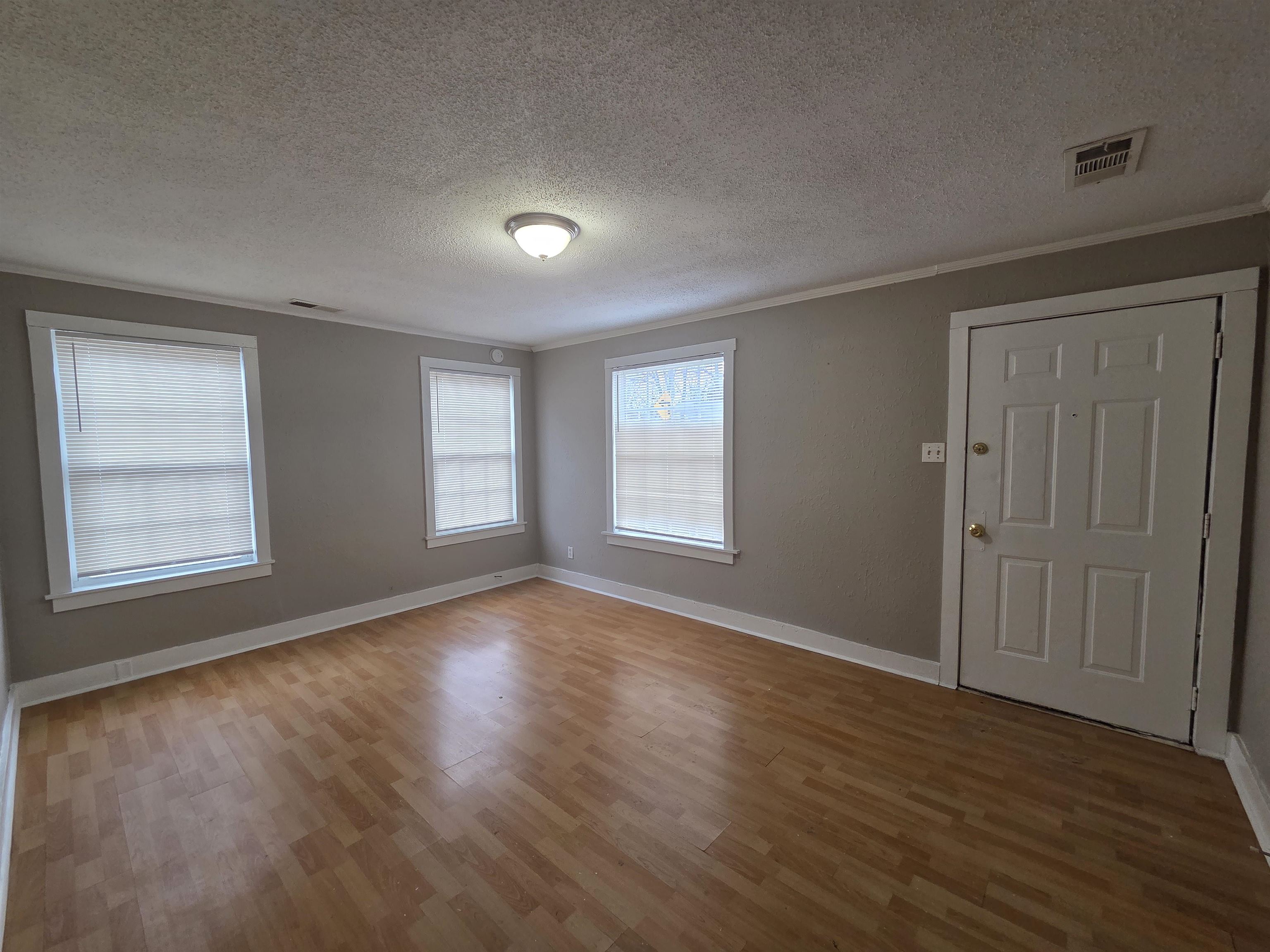 3458 Radford Road Memphis, TN 38111 - Photo 16 of 18 an empty room with wooden floor and windows