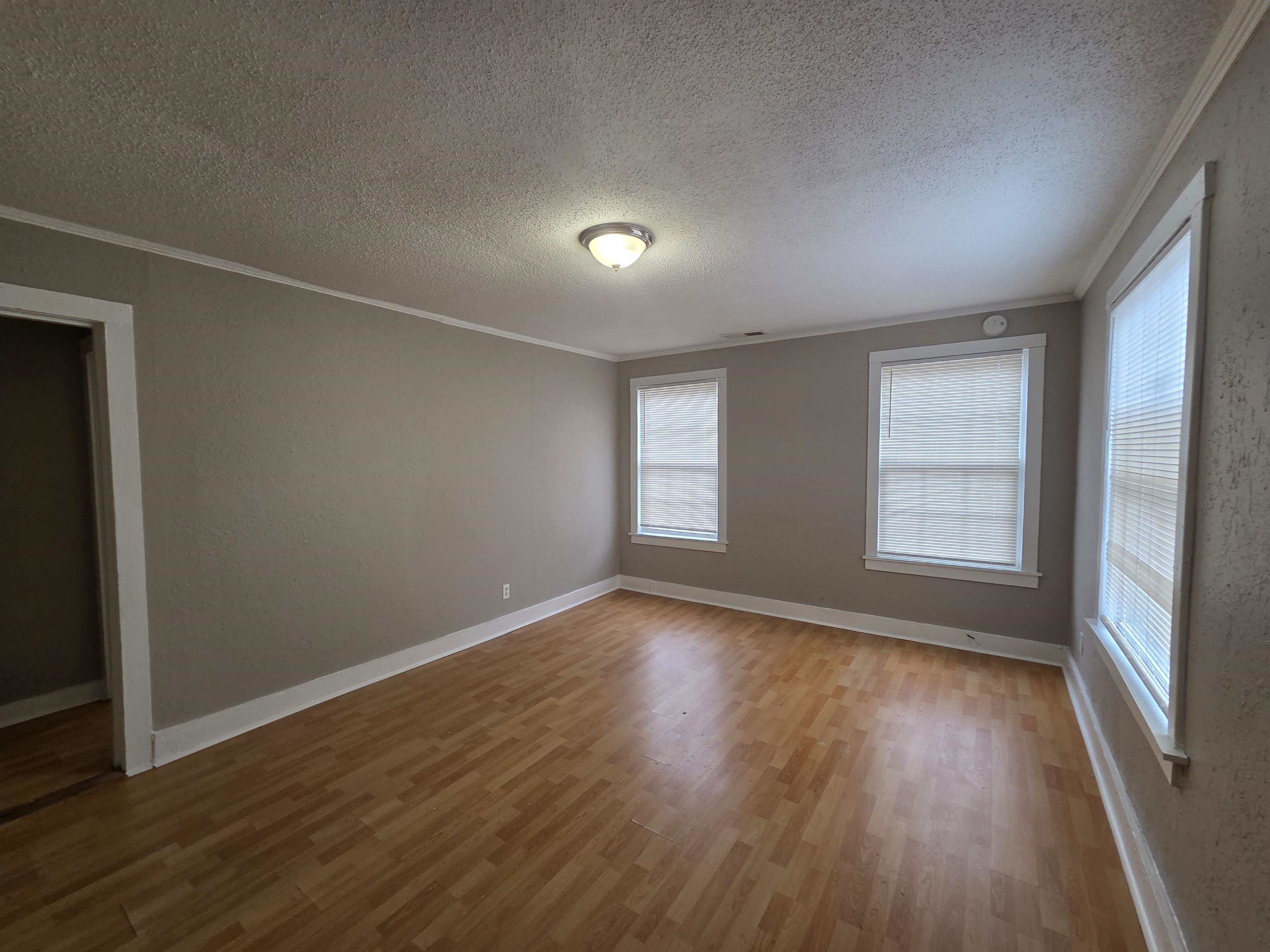 3458 Radford Road Memphis, TN 38111 - Photo 17 of 18 an empty room with wooden floor and windows