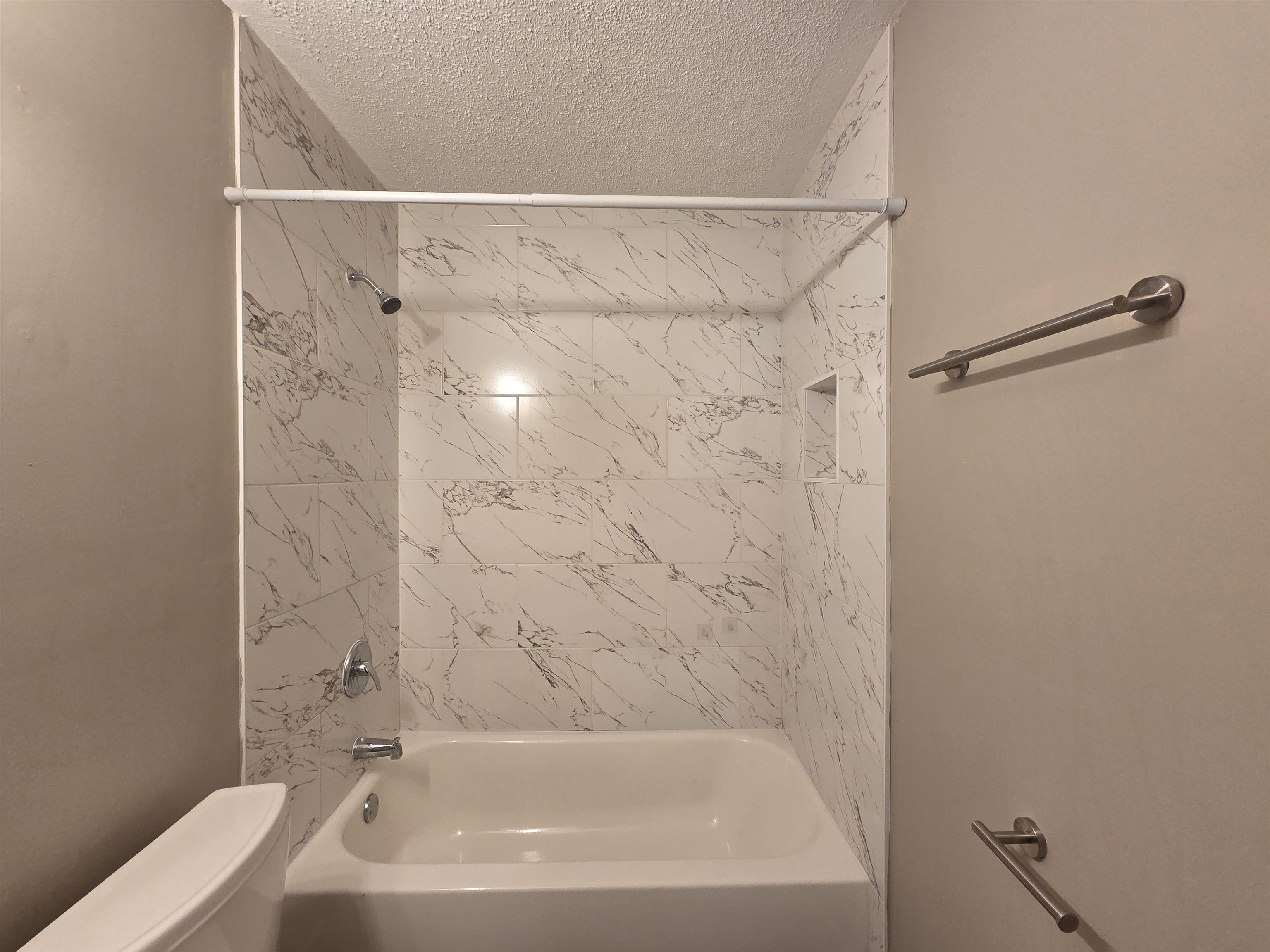 3458 Radford Road Memphis, TN 38111 - Photo 6 of 18 a bathroom with a shower and a bath tub