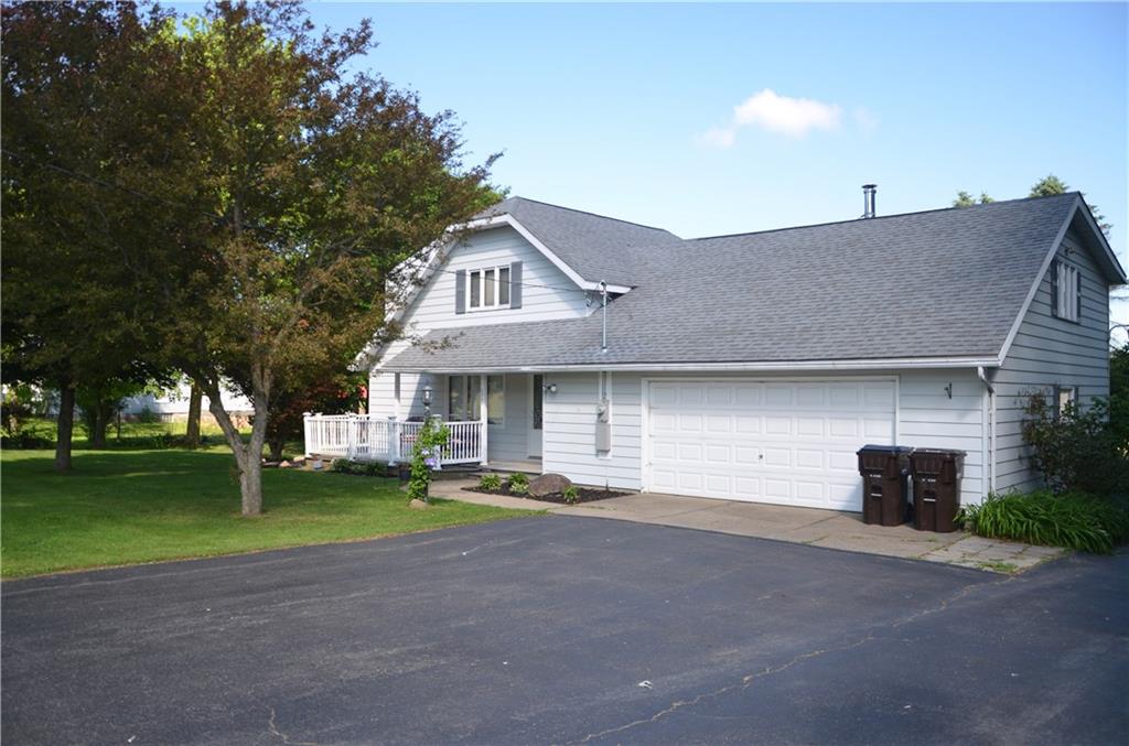 LARGE BLACKTOP DRIVEWAY. IT HAS A BASKETBALL HOOP AND IS READY FOR A GAME!