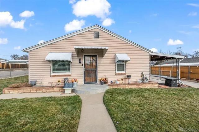 a backyard of a house with table and chairs