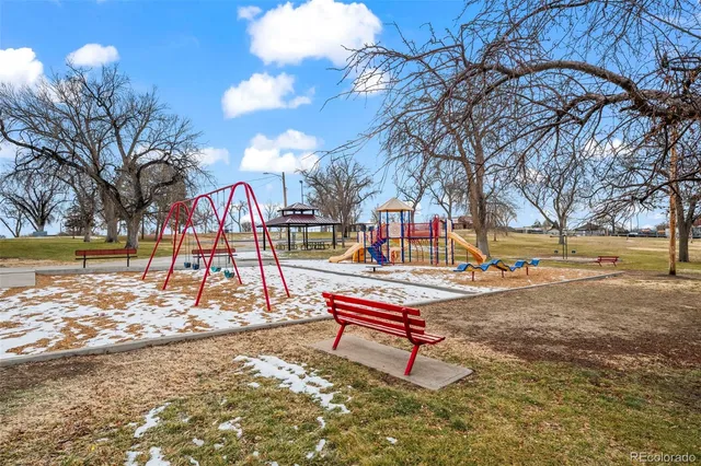 a park view with bench and trees