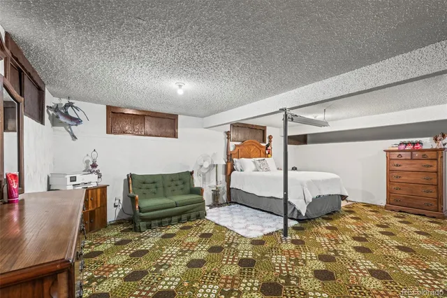 a bedroom with a bed and ceiling fan