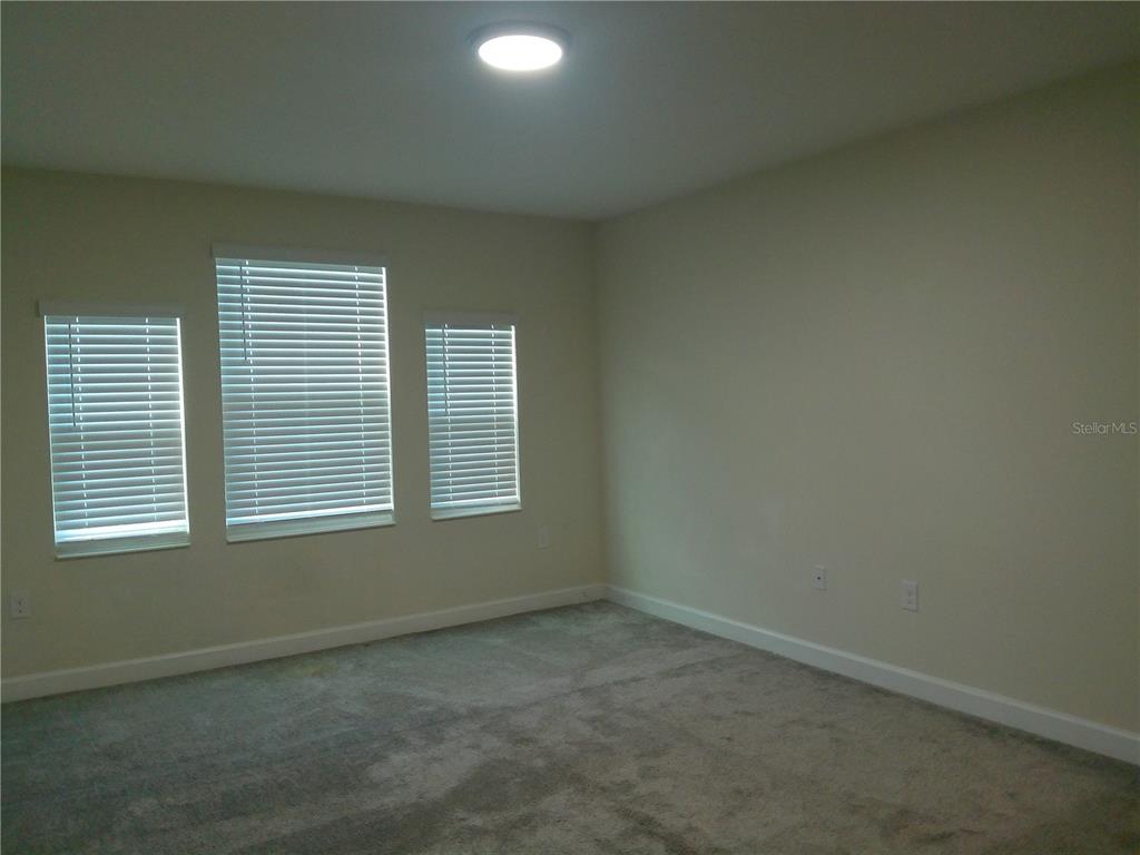 1146 Trappers Trail Loop Davenport, FL 33896 - Photo 19 of 31 an empty room with a window