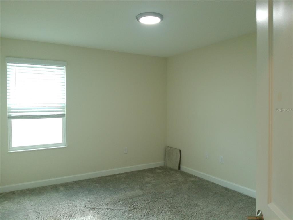 1146 Trappers Trail Loop Davenport, FL 33896 - Photo 22 of 31 an empty room with a window