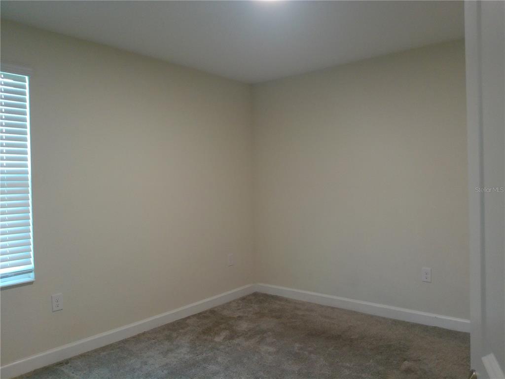 1146 Trappers Trail Loop Davenport, FL 33896 - Photo 23 of 31 an empty room with a window