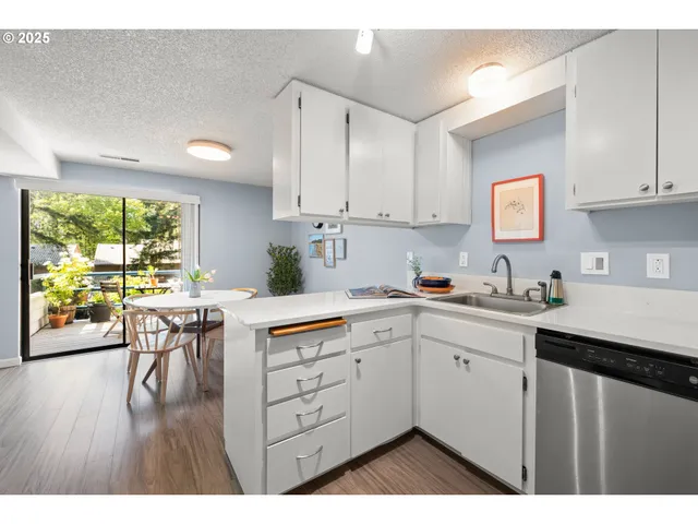 a kitchen with a sink cabinets and wooden floor