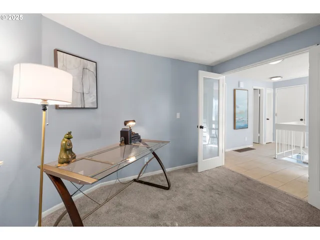 a living room with a table and chairs