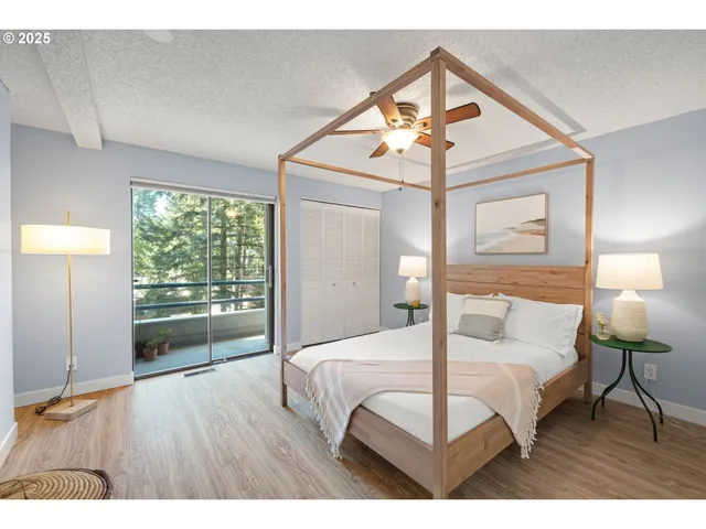 a bedroom with a bed and wooden floor