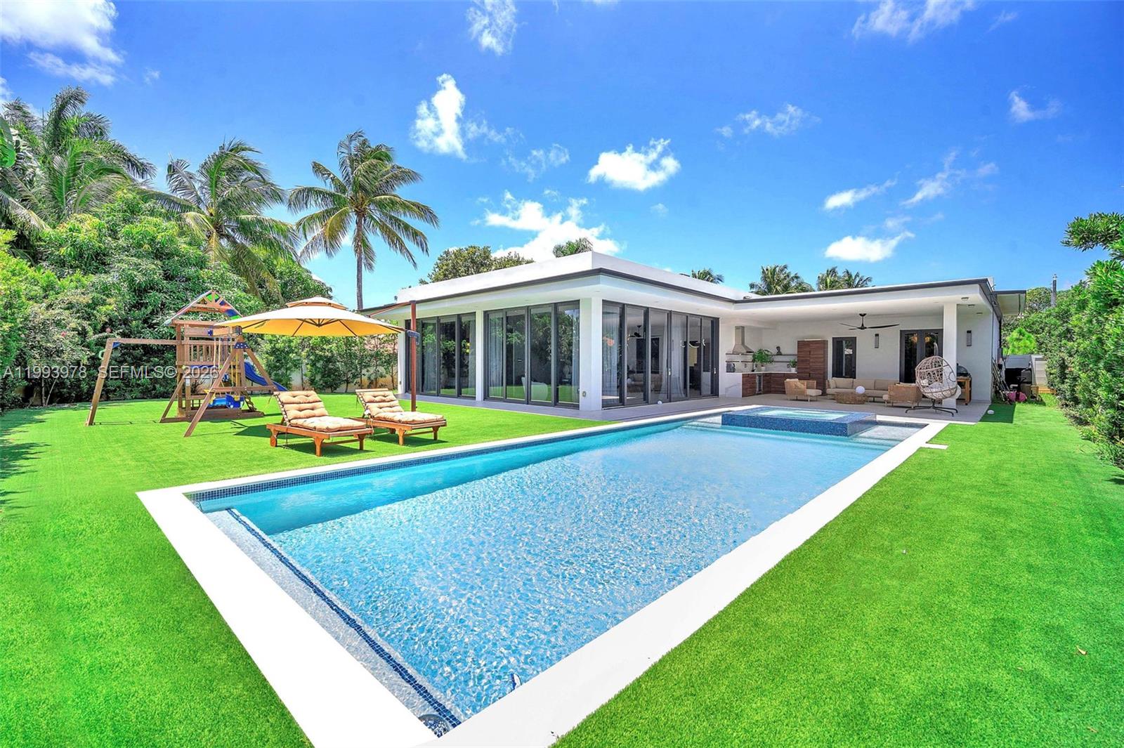 a view of a house with a backyard porch and sitting area