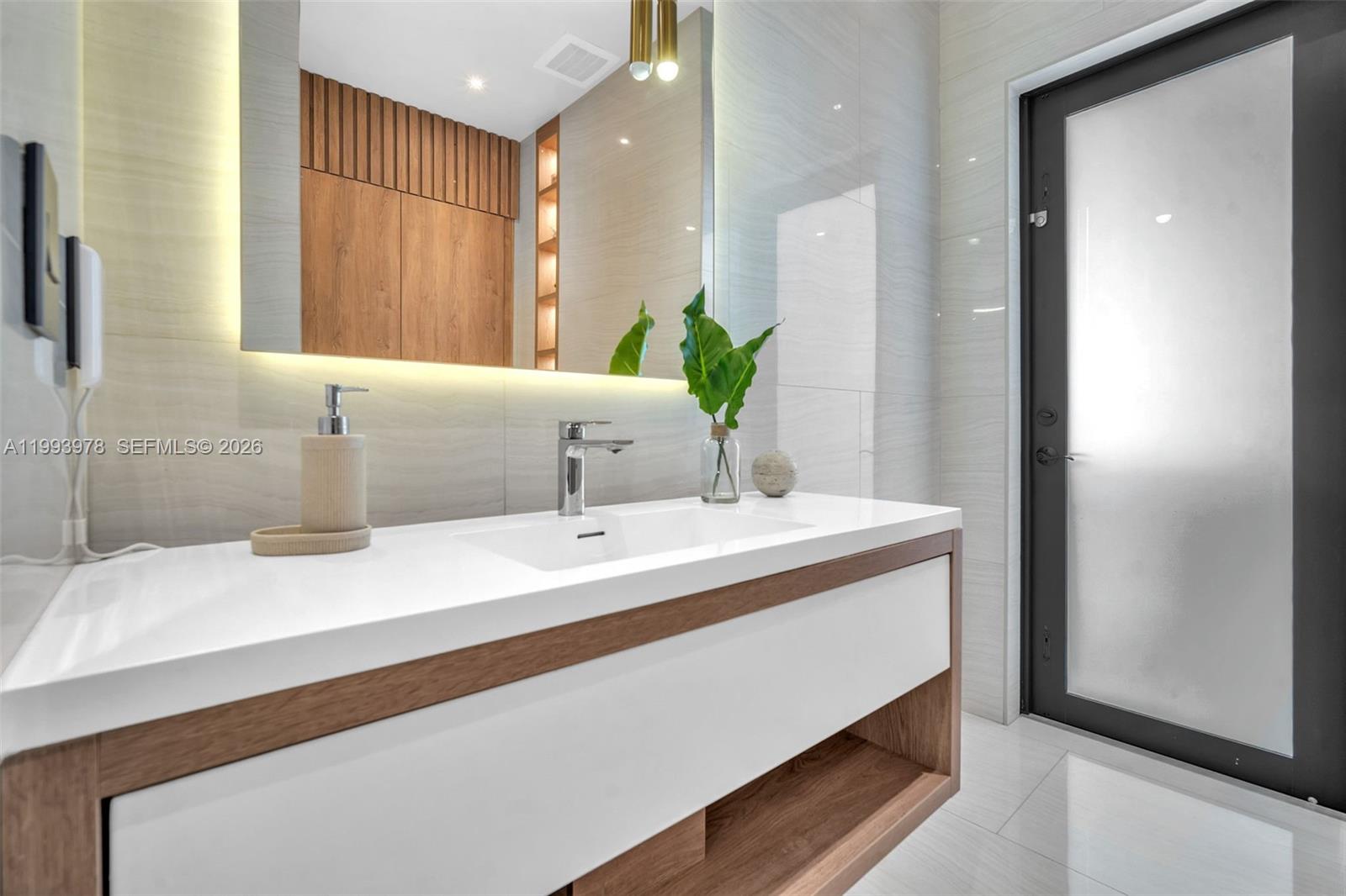 46 Northeast 162nd Street Miami, FL 33162 - Photo 27 of 44 a bathroom with a sink and a mirror