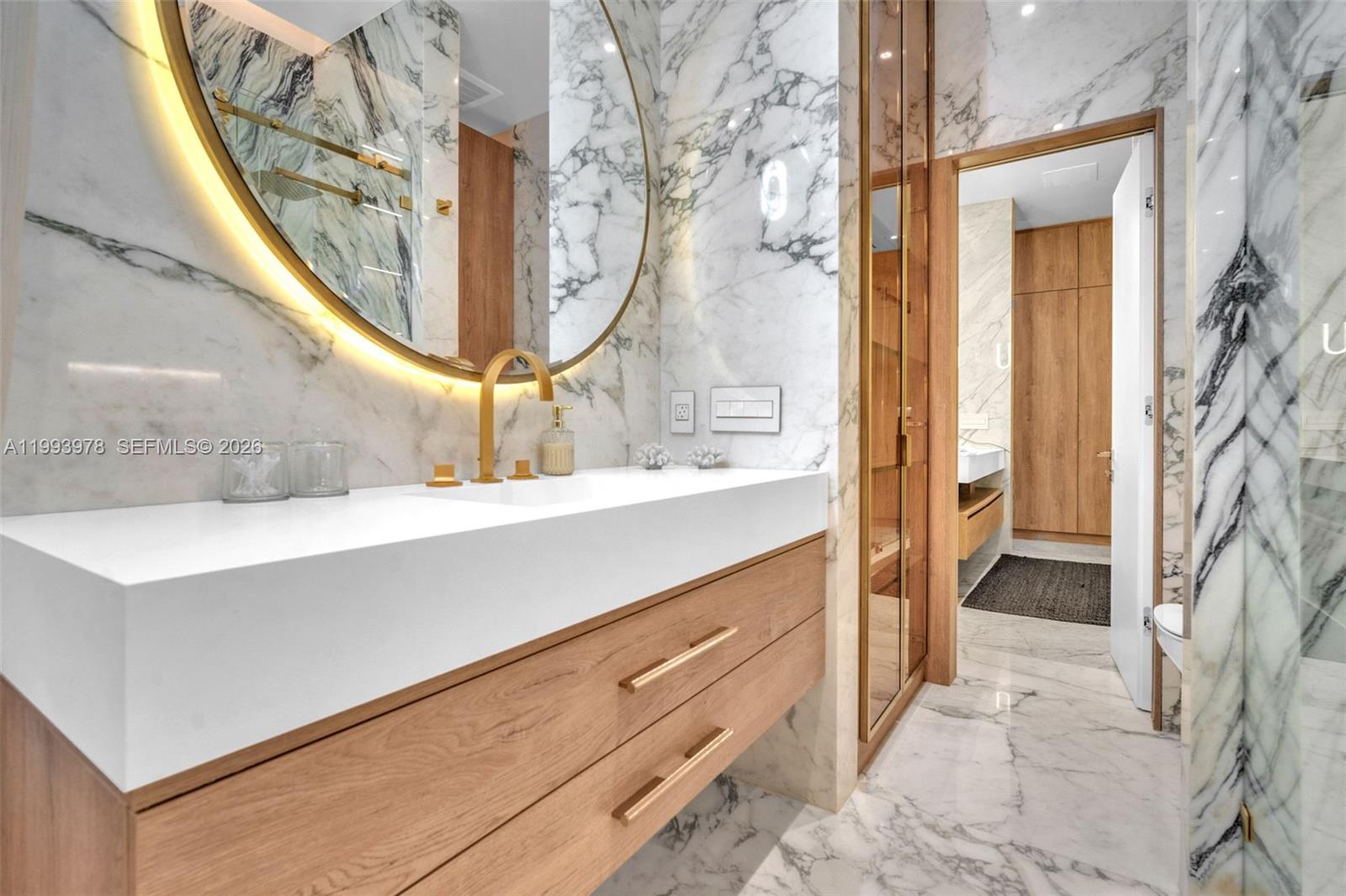 46 Northeast 162nd Street Miami, FL 33162 - Photo 3 of 44 a bathroom with a sink a mirror and a shower