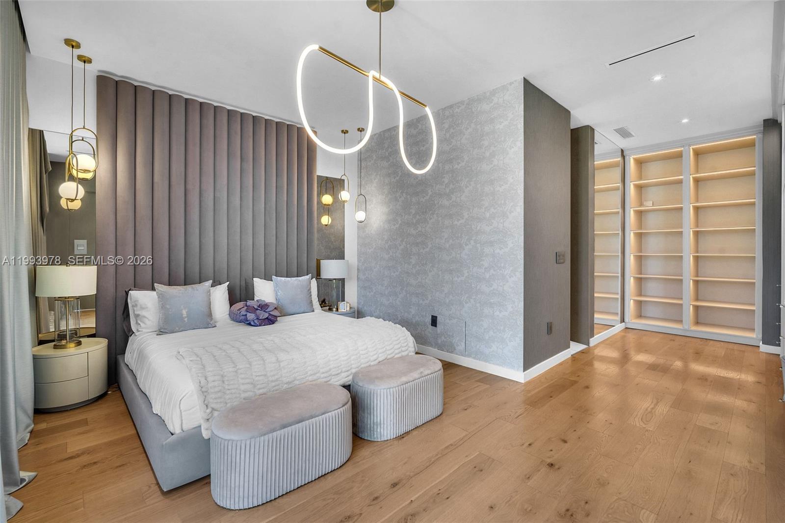 46 Northeast 162nd Street Miami, FL 33162 - Photo 4 of 44 a spacious bedroom with a bed and closet with wooden floor