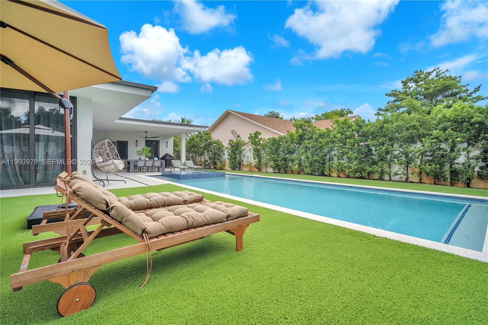 46 Northeast 162nd Street Miami, FL 33162 - Photo 8 of 44 a view of a patio with swimming pool