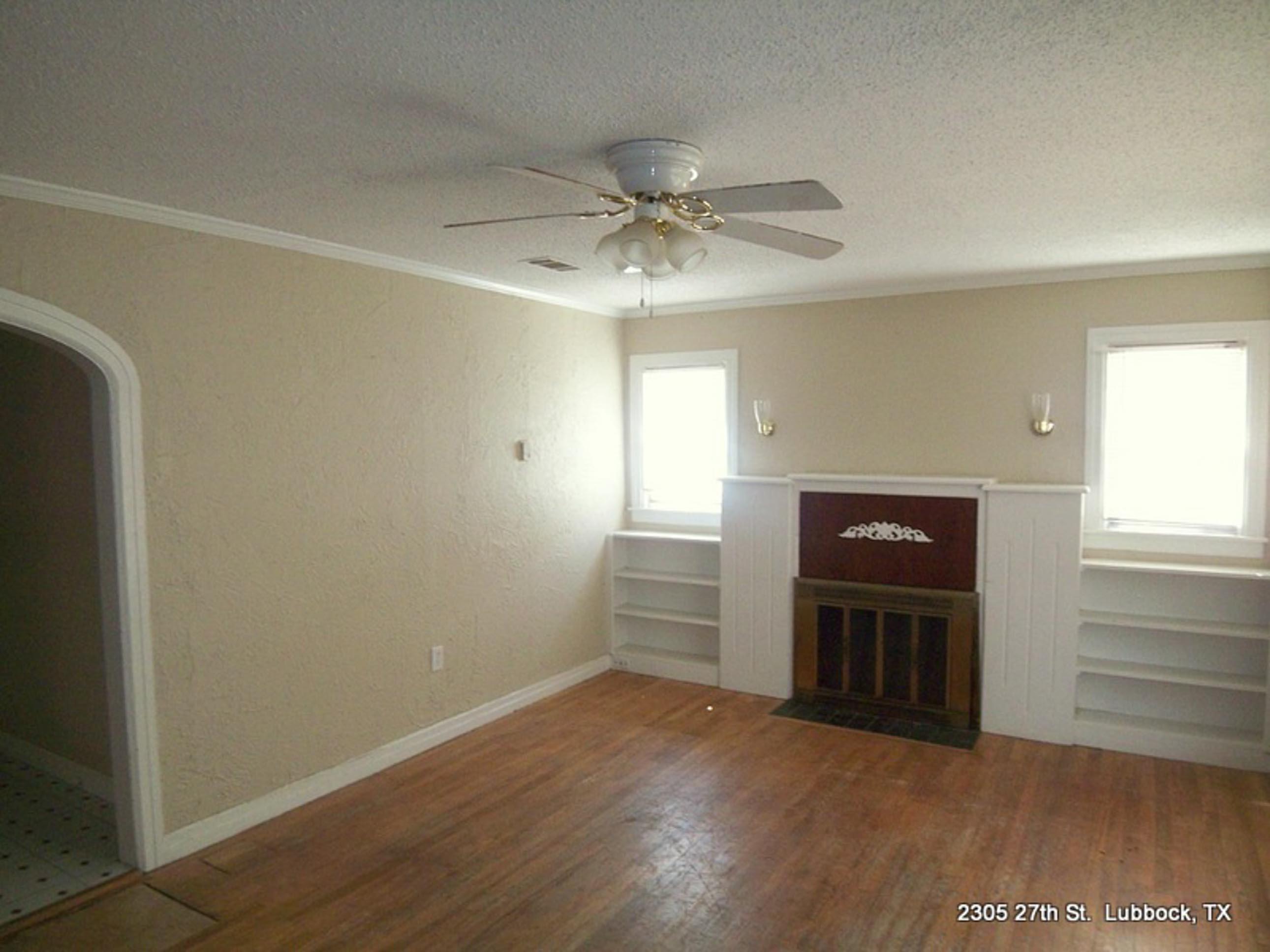 2305 27th Street, Unit FRONT Lubbock, TX 79411 - Photo 2 of 9 wooden floor in an empty room with a window