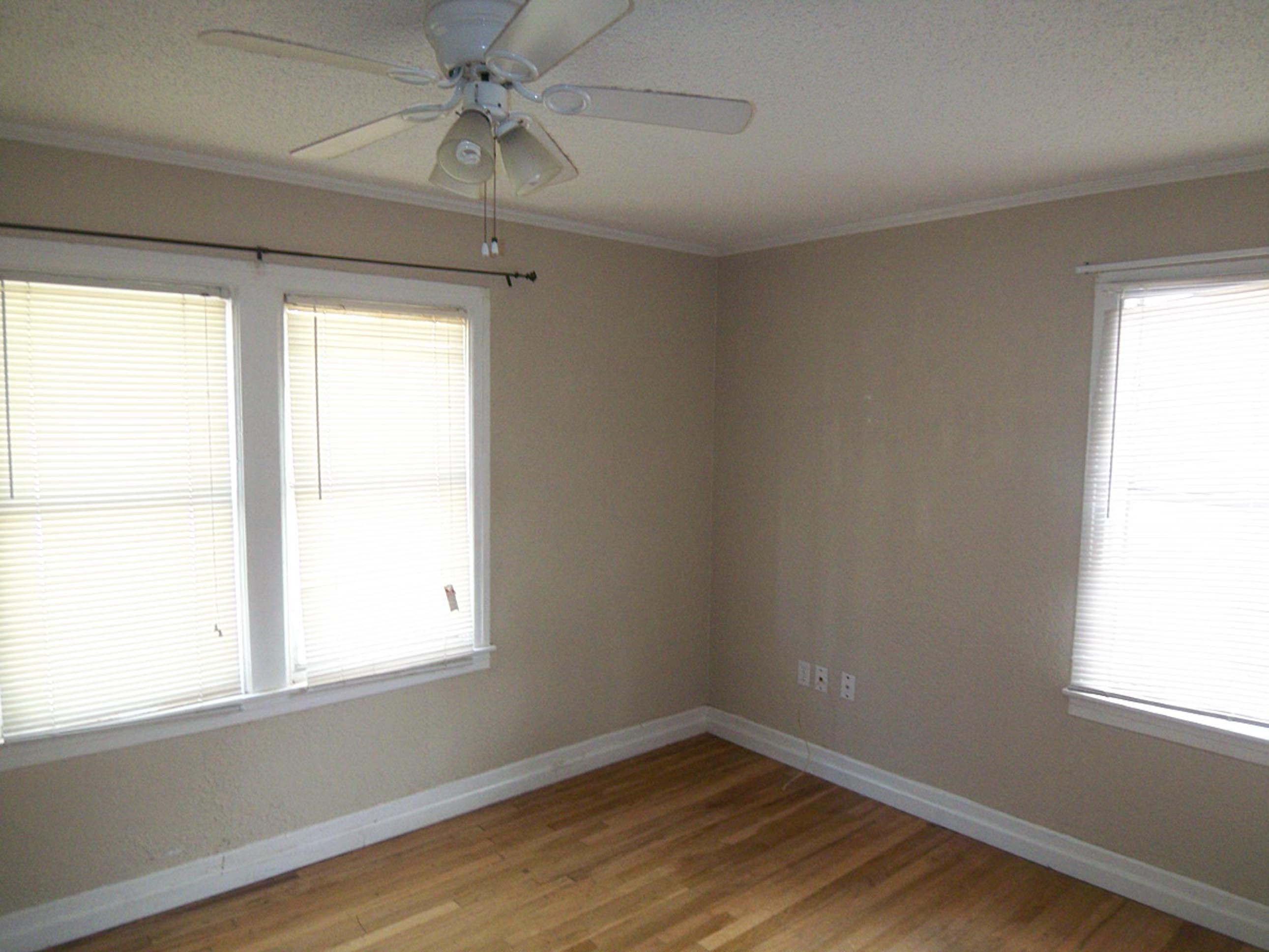 2305 27th Street, Unit FRONT Lubbock, TX 79411 - Photo 5 of 9 wooden floor in an empty room with a window