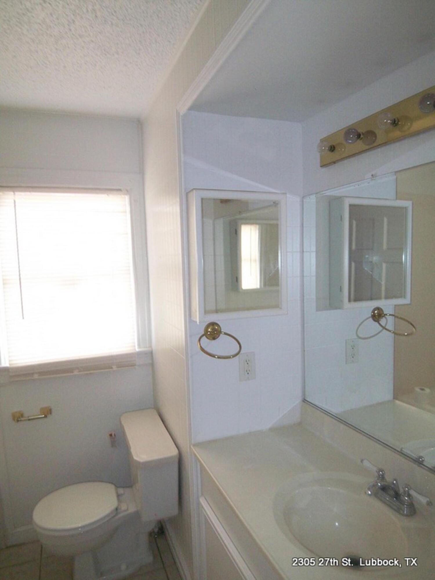 2305 27th Street, Unit FRONT Lubbock, TX 79411 - Photo 6 of 9 a bathroom with a sink toilet and shower