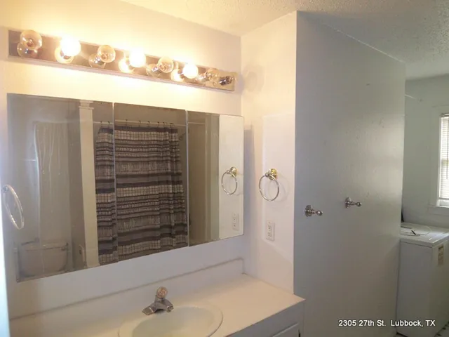 a bathroom with a shower and a sink