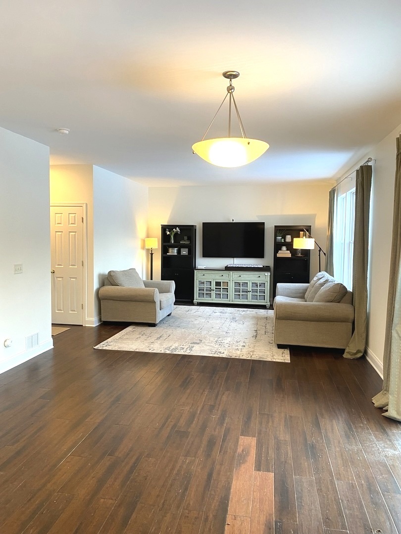 240 Copper Mountain Drive Gilberts, IL 60136 - Photo 17 of 30 a living room with furniture and a wooden floor