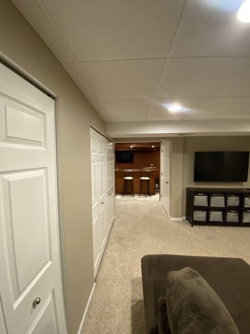 240 Copper Mountain Drive Gilberts, IL 60136 - Photo 29 of 30 a living room with furniture and a flat screen tv