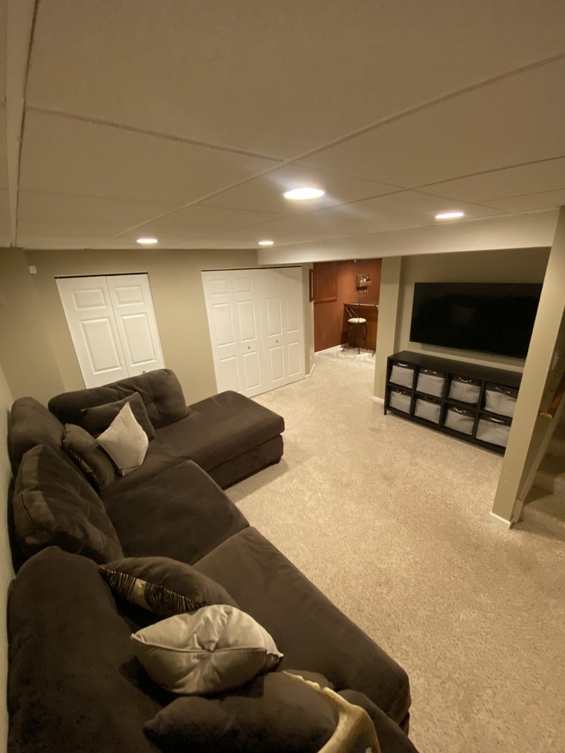 240 Copper Mountain Drive Gilberts, IL 60136 - Photo 30 of 30 a living room with furniture and a flat screen tv
