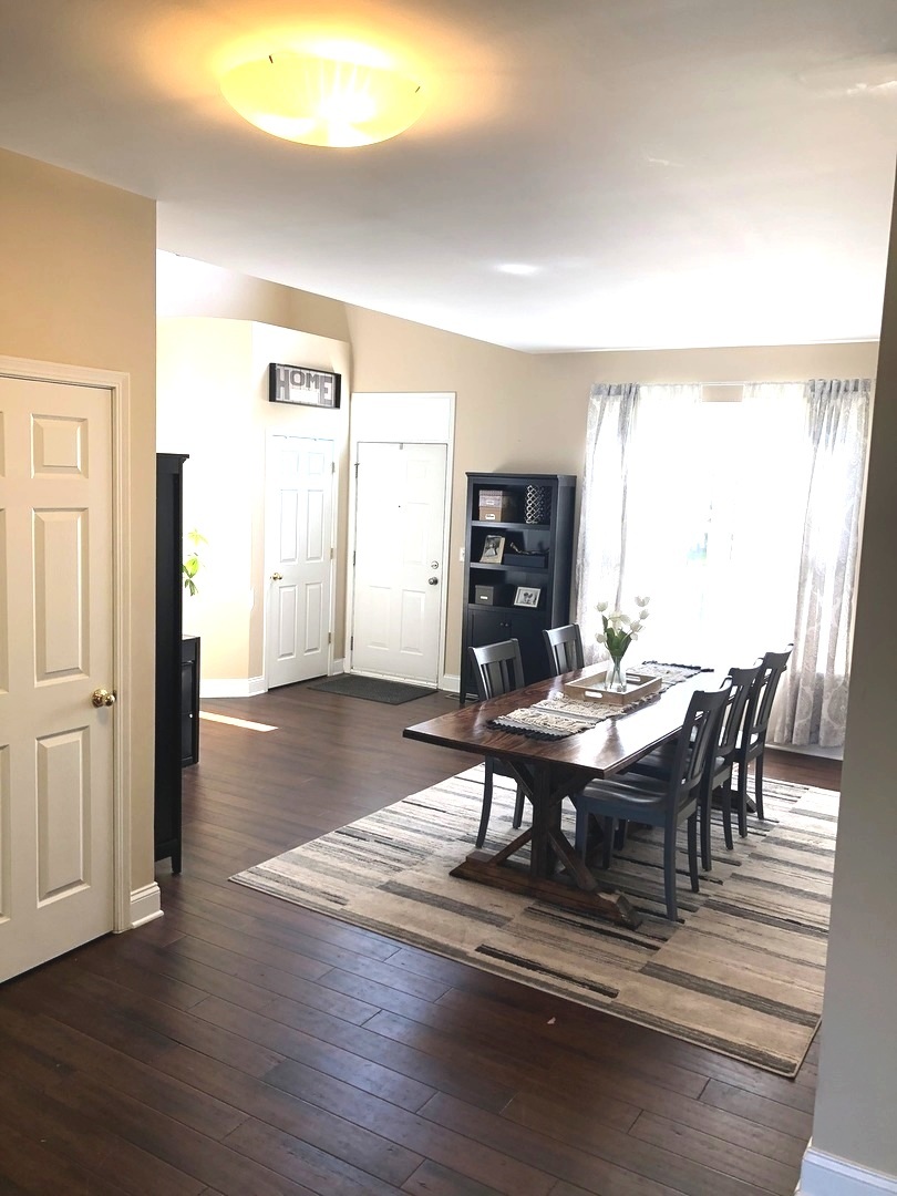 240 Copper Mountain Drive Gilberts, IL 60136 - Photo 5 of 30 a view of a dining room with furniture and wooden floor