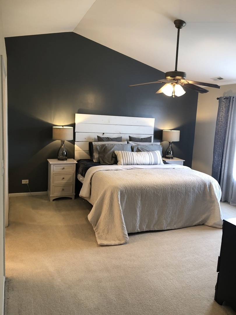 240 Copper Mountain Drive Gilberts, IL 60136 - Photo 6 of 30 a bedroom with a bed and ceiling fan