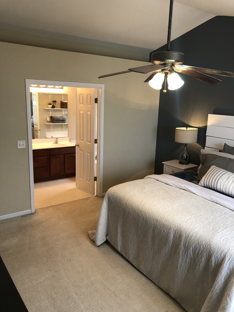 240 Copper Mountain Drive Gilberts, IL 60136 - Photo 7 of 30 a bedroom with a bed and a chandelier