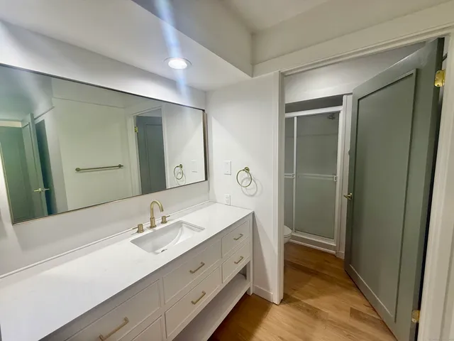 a bathroom with a double vanity sink and mirror