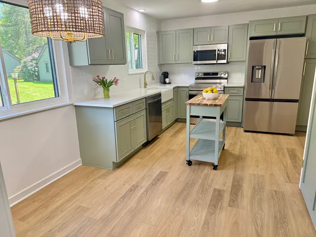 a kitchen with a sink appliances and cabinets