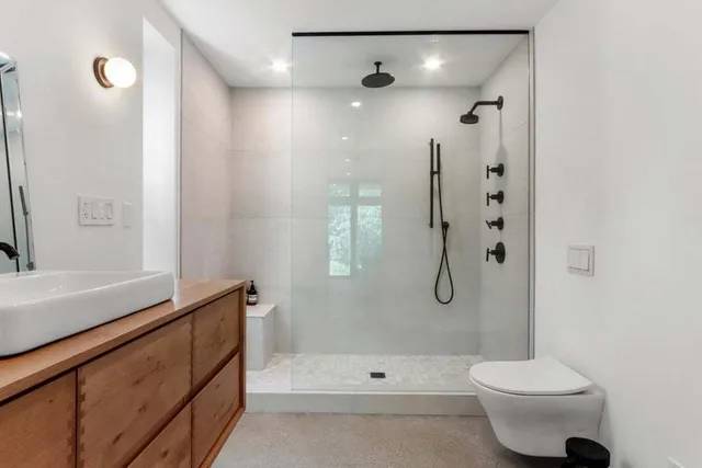 a bathroom with a shower sink and mirror