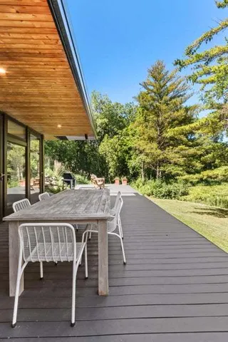 a view of a patio with table and chairs potted plants with large tree