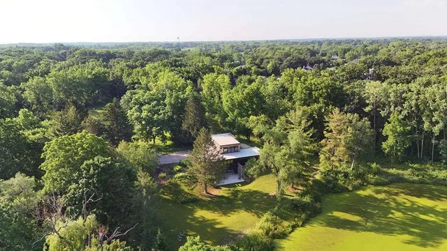 a backyard of a house with a yard and outdoor seating