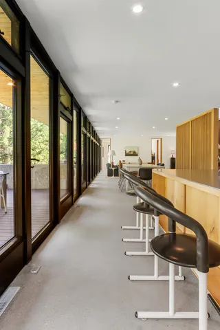 a room with lots of windows and view of living room