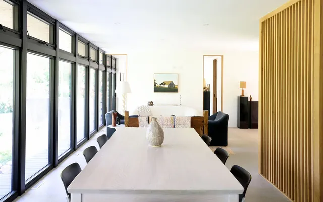 a large white couch sitting in a bedroom next to a window