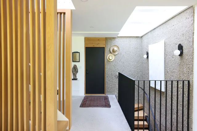 a view of a hallway with wooden floor and staircase