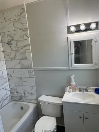 a bathroom with a toilet and bathtub