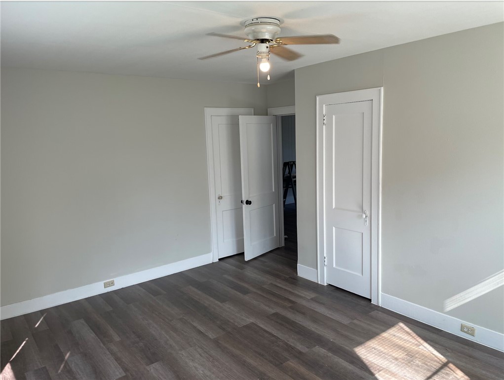 803 McAlpine Street Navasota, TX 77868 - Photo 5 of 7 wooden floor in an empty room with a window