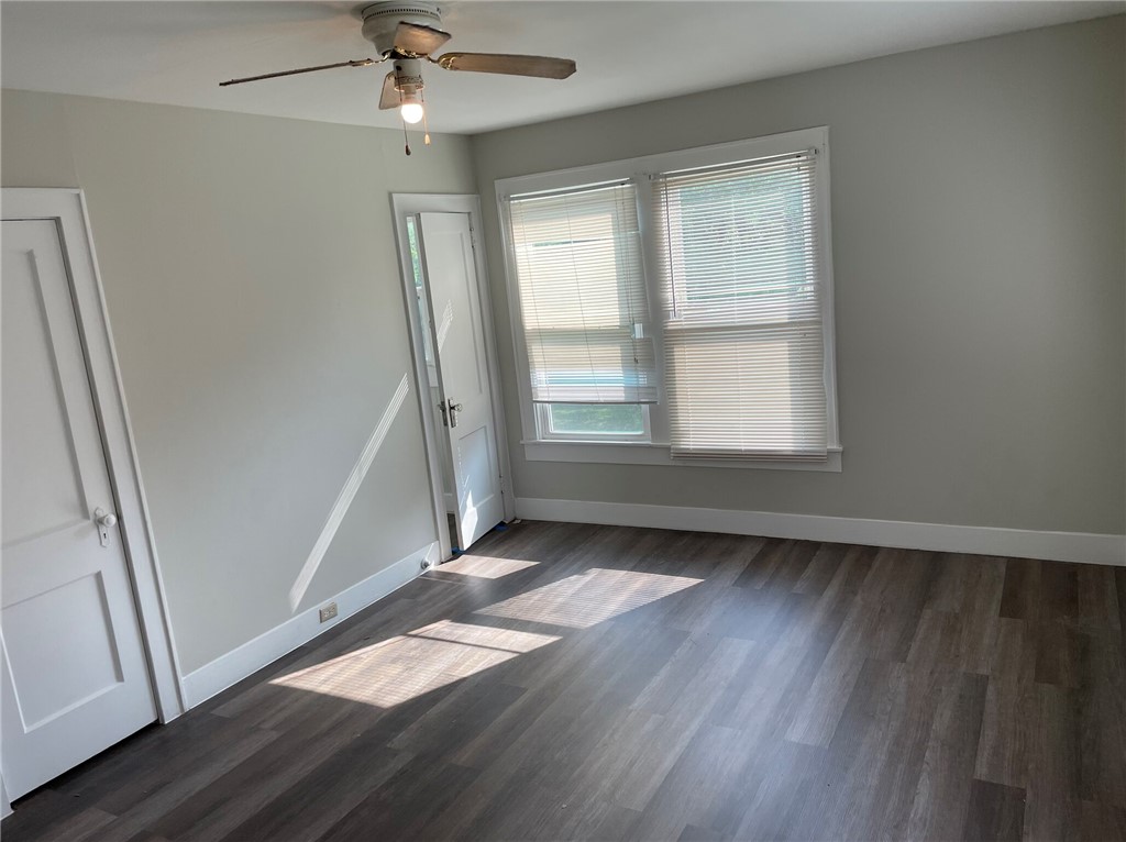 803 McAlpine Street Navasota, TX 77868 - Photo 6 of 7 an empty room with wooden floor fan and windows