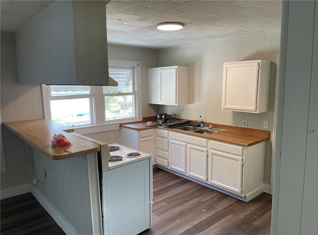 803 McAlpine Street Navasota, TX 77868 - Photo 7 of 7 a kitchen with stainless steel appliances granite countertop a sink stove and wooden floor
