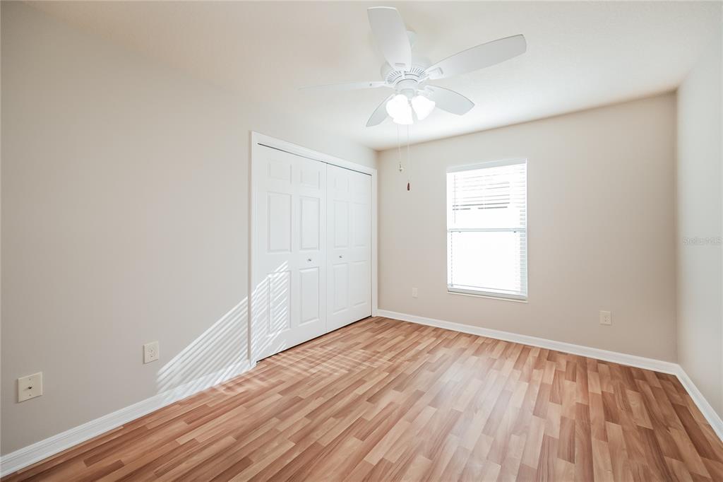 2294 Trailwinds Terrace The Villages, FL 32162 - Photo 11 of 16 an empty room with wooden floor and windows