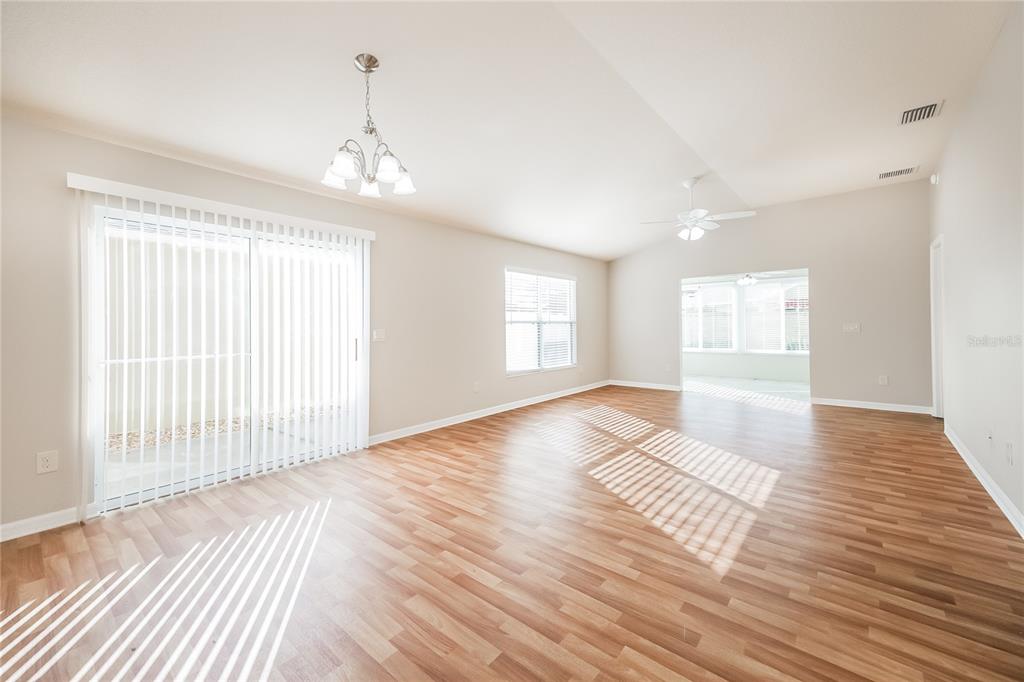 2294 Trailwinds Terrace The Villages, FL 32162 - Photo 5 of 16 a view of an empty room with wooden floor and a window