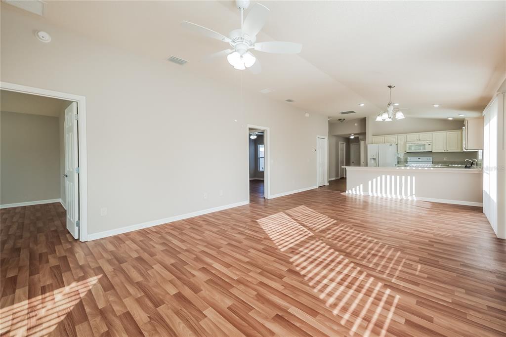 2294 Trailwinds Terrace The Villages, FL 32162 - Photo 6 of 16 a view of a kitchen with kitchen island a sink wooden floor and a refrigerator